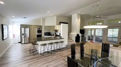 a kitchen and living room with a table and chairs at 2971 COTTAGE GROVE COURT ORLANDO 3BED in Orlando