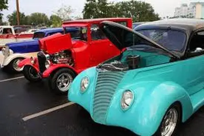 a group of old cars parked in a parking lot at Luxury Townhome Near Disney w/ Resort Amenities in Orlando