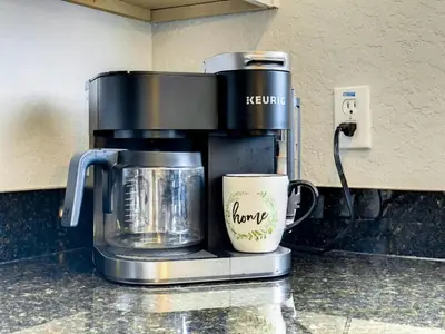 a coffee maker and a coffee cup on a counter at Luxury Townhome Near Disney w/ Resort Amenities in Orlando