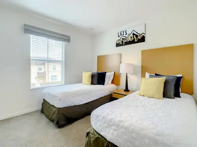 a bedroom with two beds and a window at Luxury Townhome Near Disney w/ Resort Amenities in Orlando