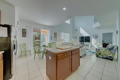 a large kitchen and living room with a table at 5 Bedroom private pool home in Veranda Palms in Kissimmee