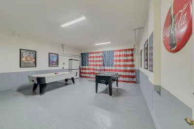a room with a pool table and an american flag at 5 Bedroom private pool home in Veranda Palms in Kissimmee