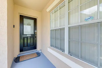 a front door of a house with a mat in front at Pool home close to Golfing and Theme parks in Orlando