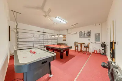 a room with a pool table and a ping pong ball at 6 Bed villa close to disney in Kissimmee