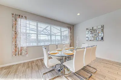 a dining room with a table and chairs and a window at 6 Bed villa close to disney in Kissimmee