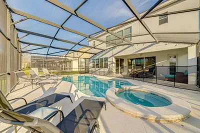 an indoor swimming pool with a glass ceiling at 6 Bed villa close to disney in Kissimmee