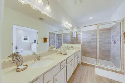 a bathroom with a double sink and a shower at 6 Bed villa close to disney in Kissimmee