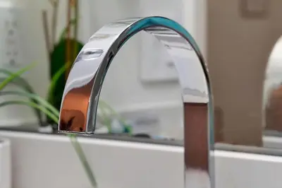 a bathroom sink faucet in front of a mirror at Magical serenity 3 bedroom pool home in Orlando