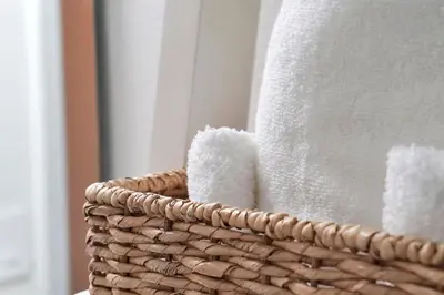 a basket filled with white towels in a bathroom at Magical serenity 3 bedroom pool home in Orlando