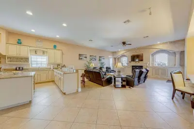 a large kitchen with couches and a living room at Luxury Pool Home - Disney View in Orlando