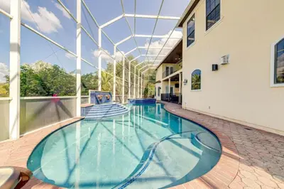a swimming pool in a building with a glass ceiling at Luxury Pool Home - Disney View in Orlando
