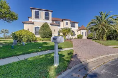 a house with a mailbox in front of a driveway at Luxury Pool Home - Disney View in Orlando