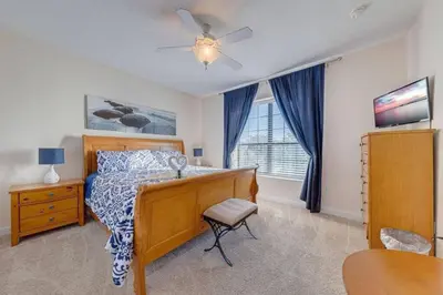 a bedroom with a bed and a ceiling fan at Luxury Pool Home - Disney View in Orlando