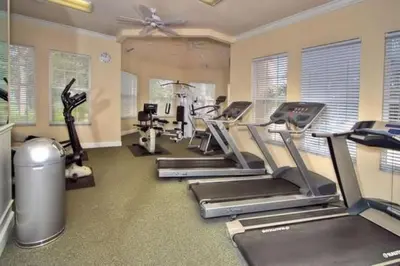 a gym with treadmills and elliptical machines at Mickey's Play House: Family Fun & Comfort in Kissimmee