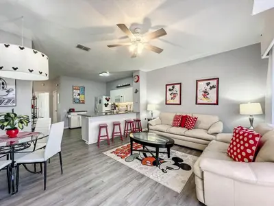 a living room with a couch and a table at Mickey's Play House: Family Fun & Comfort in Kissimmee