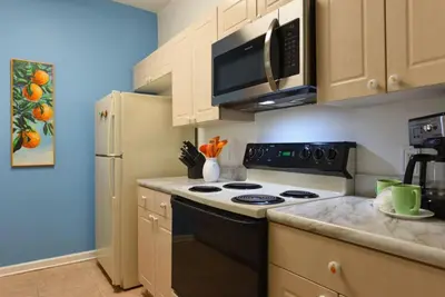 a kitchen with a stove and a refrigerator at Orangebaum Condo: 8 Min to Disney + Resort Perks in Kissimmee