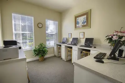 an office with three desks with computers on them at Orangebaum Condo: 8 Min to Disney + Resort Perks in Kissimmee
