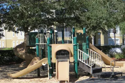 a playground with a slide in a park at Orangebaum Condo: 8 Min to Disney + Resort Perks in Kissimmee