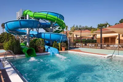a water slide in a pool at a resort at Regal Oaks Retreat: Pool, Hot Tub & Near Disney in Kissimmee