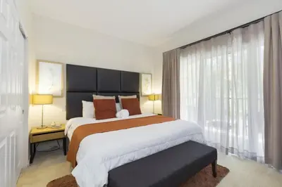 a bedroom with a large bed and a window at Regal Oaks Retreat: Pool, Hot Tub & Near Disney in Kissimmee