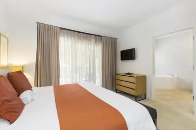 a bedroom with a large bed and a television at Regal Oaks Retreat: Pool, Hot Tub & Near Disney in Kissimmee