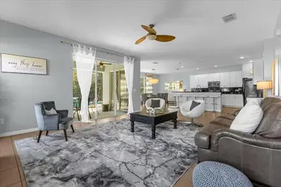 a living room with a couch and a ceiling fan at Spacious 7-Bedroom Home at Bella Vida Resort with Conservation View in Kissimmee