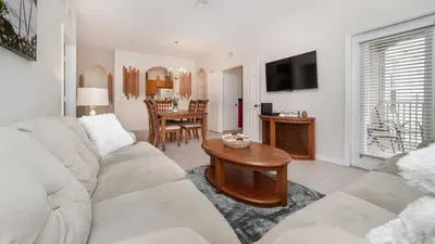 a living room with a white couch and a table at ALM2774-204 in Orlando