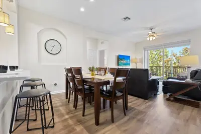a dining room and living room with a table and chairs at ALM2774-403 in Orlando