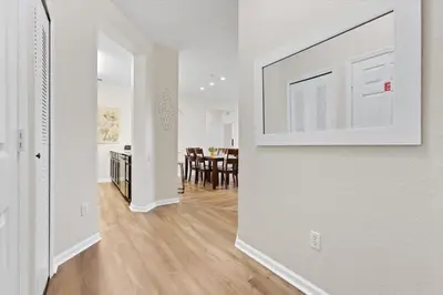 a room with a white wall with a picture on the wall at ALM2774-403 in Orlando