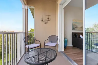 a porch with two chairs and a table on a balcony at ALM2774-403 in Orlando