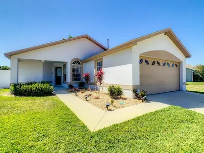 a house with a garage at Relax Away Villa: Private Pool Home Near Disney in Orlando