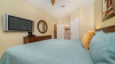 a bedroom with a bed and a flat screen tv at ALM2781-103 in Orlando