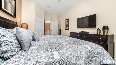 a bedroom with a bed and a flat screen tv at ALM2809-101 in Orlando