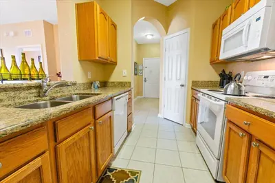 a kitchen with wooden cabinets and a sink at ALM2813-403 in Orlando