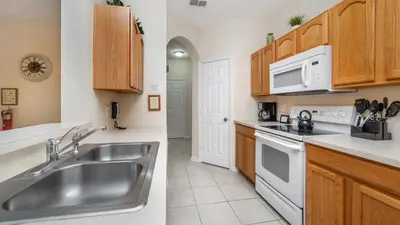 a kitchen with a stainless steel sink and white appliances at ALM2821-104 in Orlando