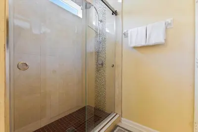 a shower with a glass door in a bathroom at DVL2638 in Orlando