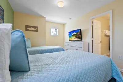 a bedroom with a blue bed and a television at DVL2638 in Orlando