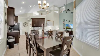 a dining room and kitchen with a table and chairs at FP8176 Windsor Palms Resort Vacation Home in Kissimmee