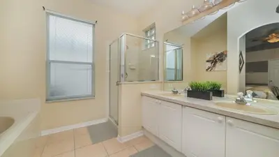 a bathroom with two sinks and a shower at FP8190 Windsor Palms Resort Vacation Home in Kissimmee