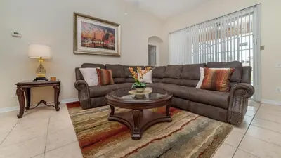 a living room with a couch and a table at FP8190 Windsor Palms Resort Vacation Home in Kissimmee