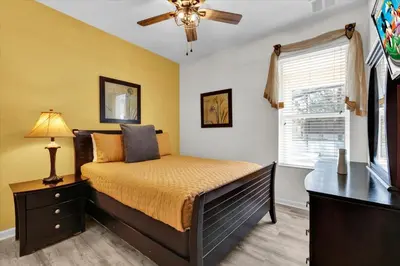 a bedroom with a bed and a ceiling fan at GRS7756 in Orlando
