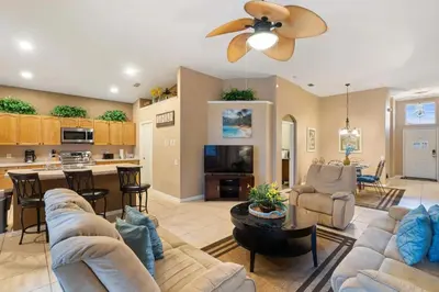 a large living room with a couch and a kitchen at FP8104 Windsor Palms Resort Vacation Home in Kissimmee