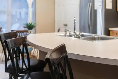 a kitchen with a counter with chairs and a sink at FP8104 Windsor Palms Resort Vacation Home in Kissimmee
