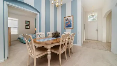 a dining room with a wooden table and chairs at FP8150 Windsor Palms Resort Vacation Home in Kissimmee