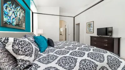 a bedroom with a large bed and a tv at FP8150 Windsor Palms Resort Vacation Home in Kissimmee