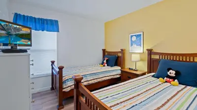 a bedroom with two beds and a tv at FP8159 Windsor Palms Resort Vacation Home in Kissimmee