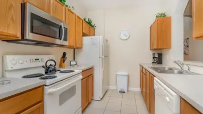 a kitchen with a sink and a white refrigerator at CW7650-204 Windsor Hills Resort Vacation Condo in Orlando