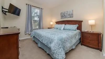 a bedroom with a bed and a tv and a window at CW7650-204 Windsor Hills Resort Vacation Condo in Orlando
