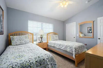 a bedroom with two beds and a mirror at Luxury 3-bdr house with pool next to Disney in Orlando