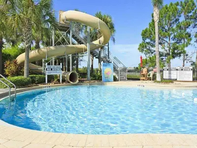 a large swimming pool with a water slide at Luxury 3-bdr house with pool next to Disney in Orlando